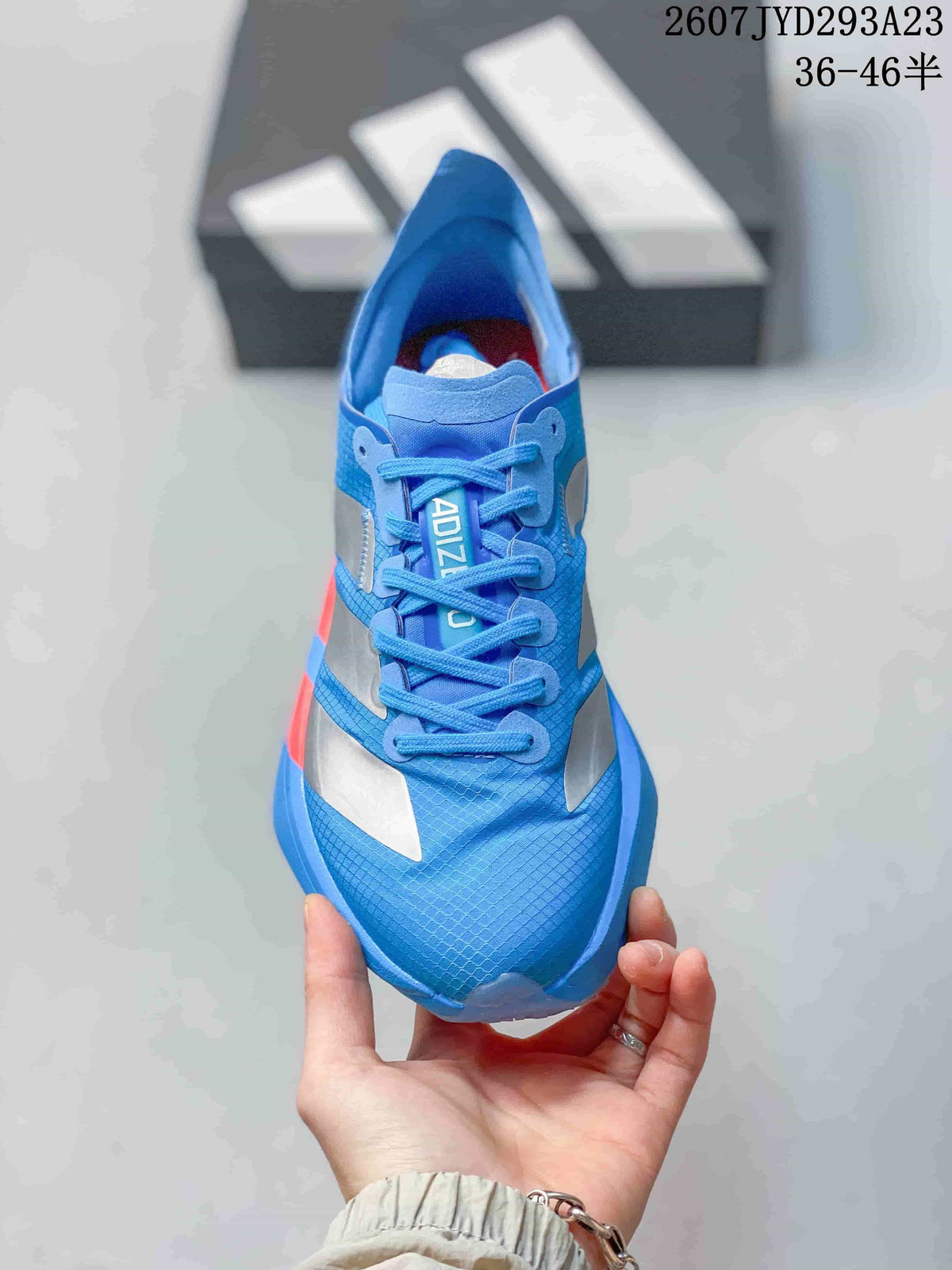 Top view of the blue lace-up sneaker showing the patterned upper, silver overlays and branded tongue.