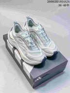 Pair of light gray and pale blue Adidas Holo Peak trail running shoes on a shoebox