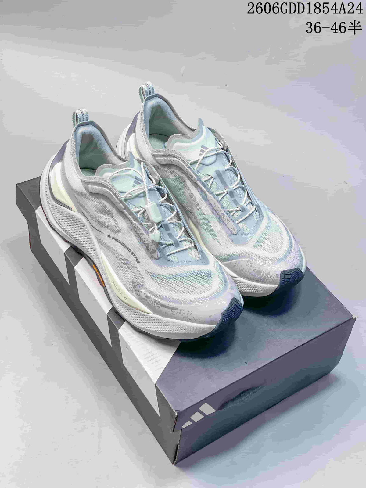 Pair of light gray and pale blue Adidas Holo Peak trail running shoes on a shoebox