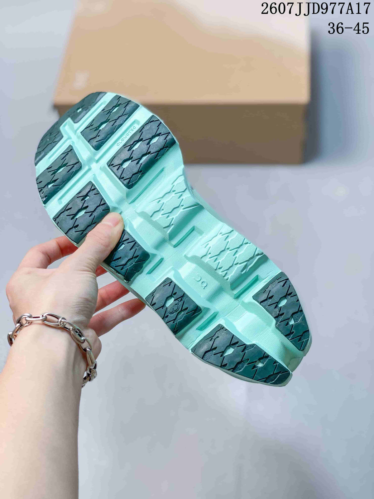 Underside view of the mint green sneaker showing segmented outsole sections and dark textured traction areas.