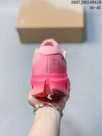 Rear view of the pink sneaker showing the padded collar, heel branding, and outsole structure.