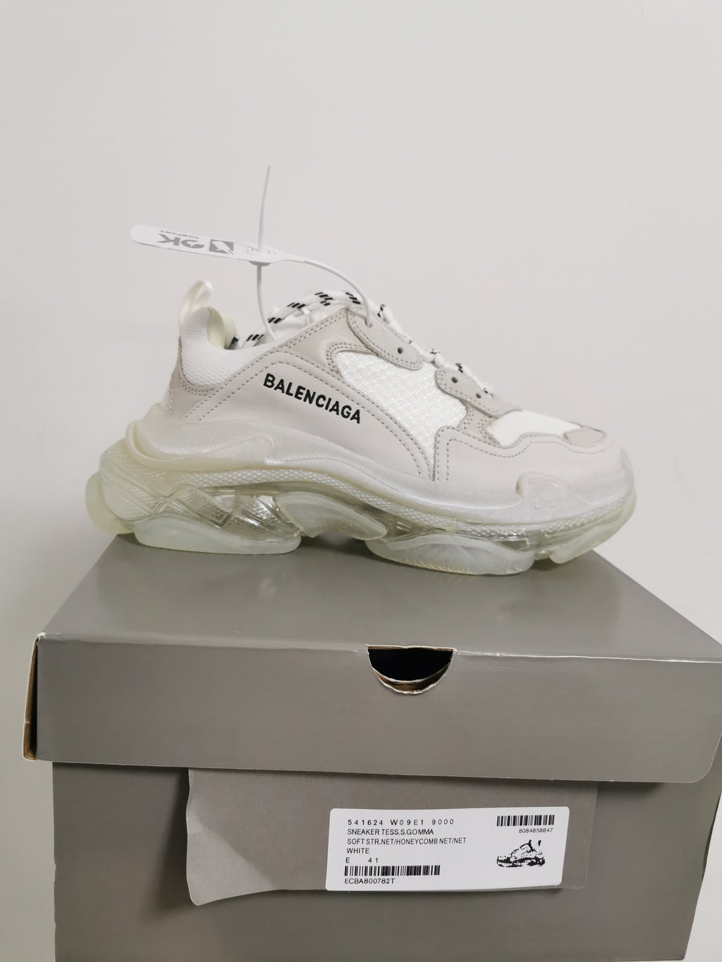 White Balenciaga sneaker displayed on its box, with the box label showing style code 541624 W09E1 9000 and EU 41.