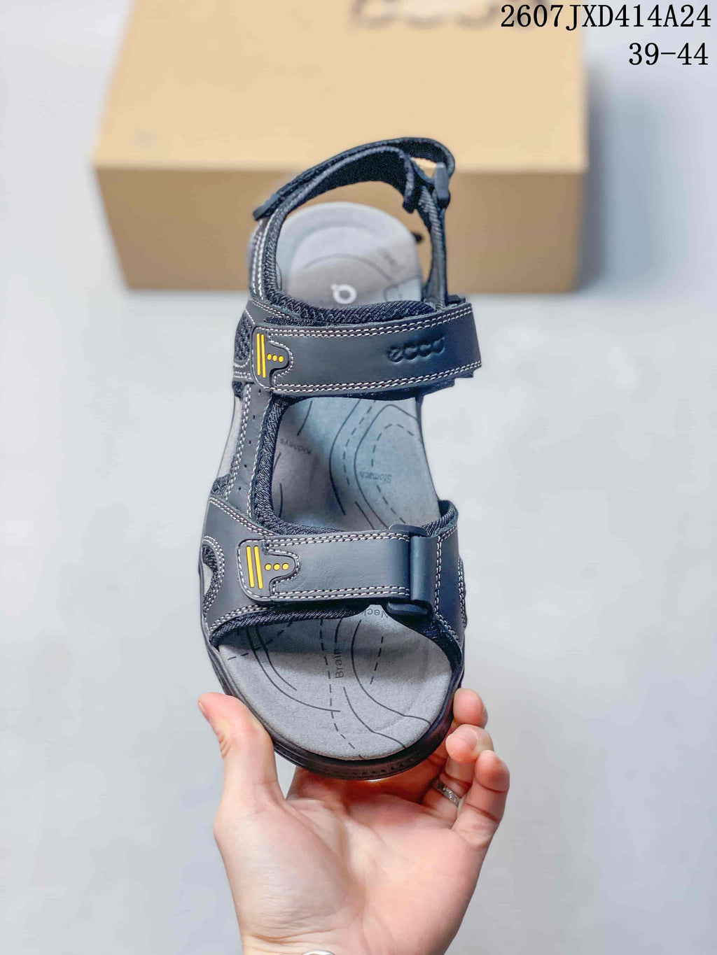 Top view of a dark black open-toe sandal showing its adjustable straps, cushioned footbed and printed contour details.