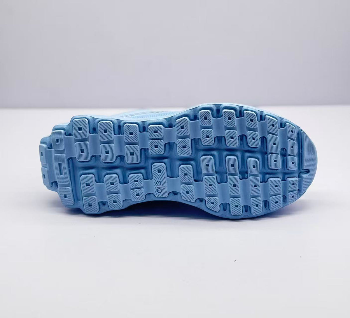 Underside view showing the patterned rubber-style outsole tread.