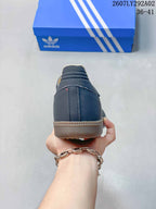 Rear view of a dark navy Adidas Samba Jane shoe showing the heel stitching and gum-colored sole.