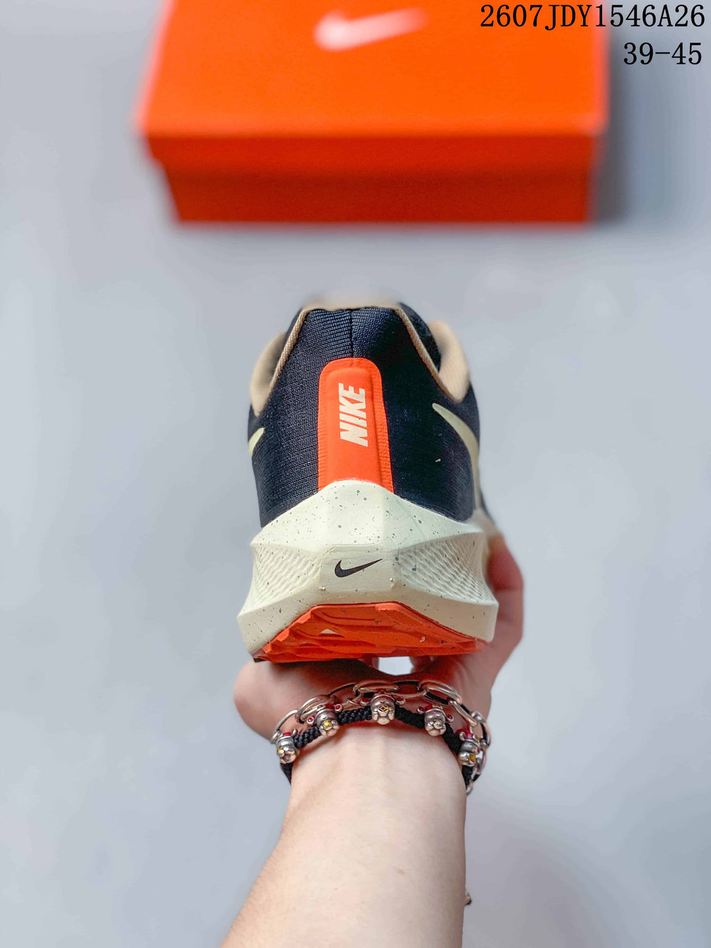 Rear view of the sneaker showing the Nike heel mark, orange heel detail, and layered cream-colored midsole.