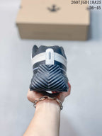 Rear view highlighting the layered black-and-white heel construction and textured heel outsole.