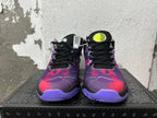 Pair of black and purple Nike basketball-style sneakers viewed from the front
