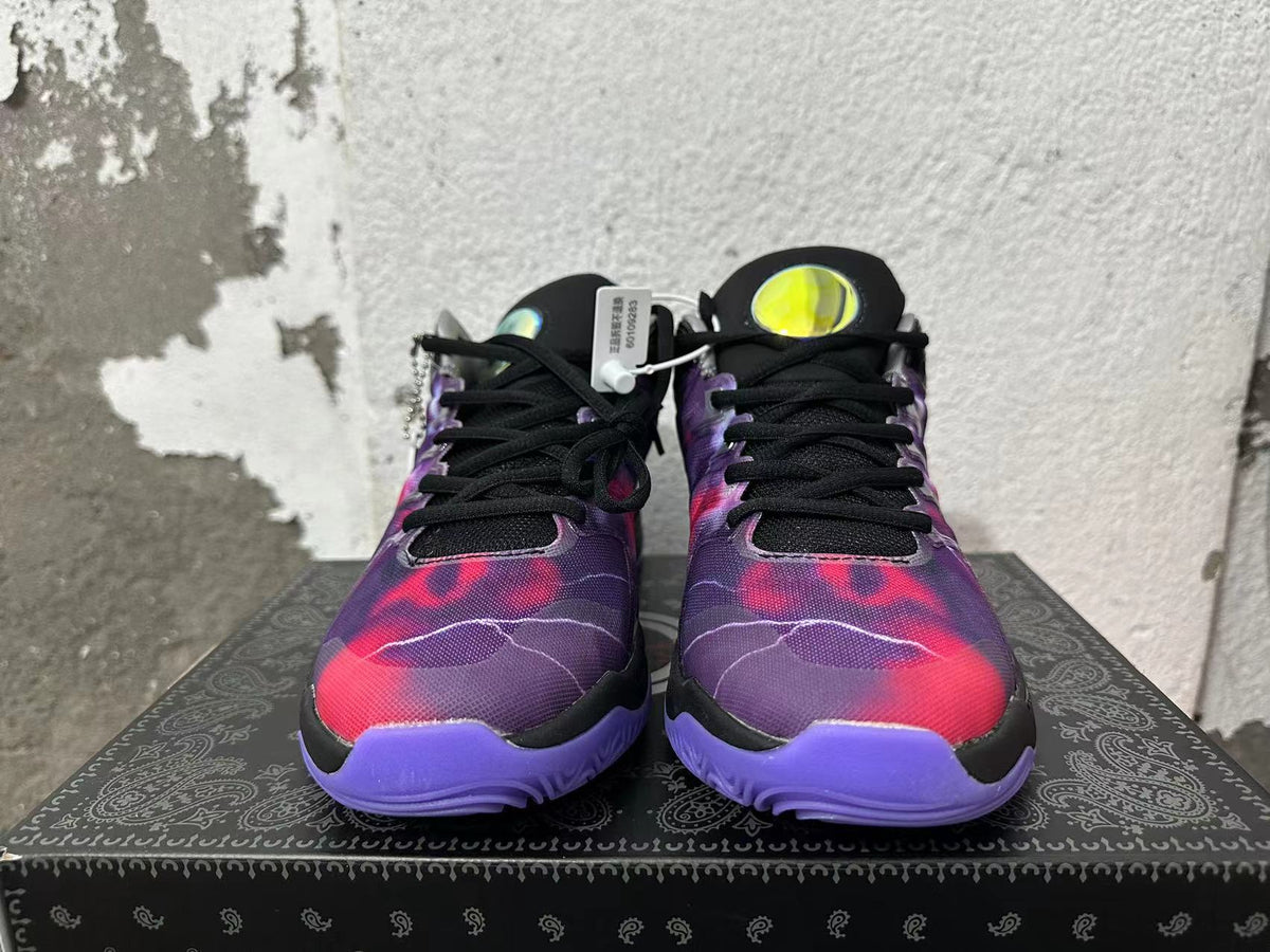 Pair of black and purple Nike basketball-style sneakers viewed from the front