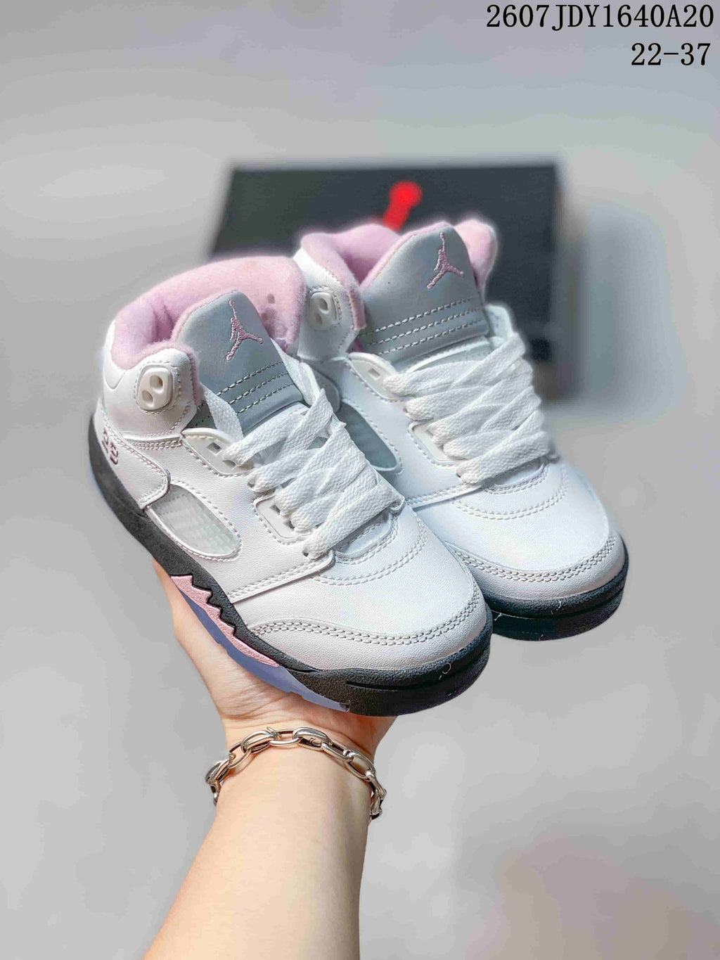 Pair of white, gray, pink, and black Jordan Air Jordan 5 Retro kids sneakers shown from above.