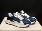 Three-quarter view of the sneaker pair highlighting the layered upper panels, white laces, and contrast midsoles.