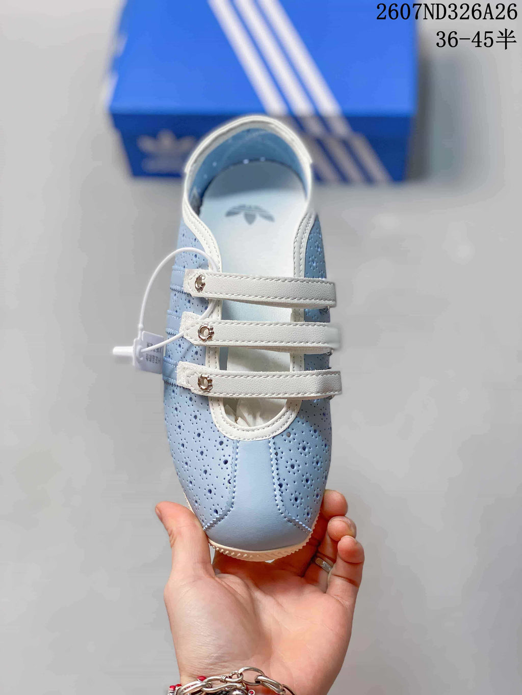 Top view showing the rounded toe, perforated panels, white trim and three adjustable straps.