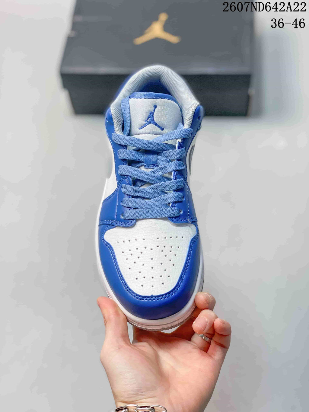Top view showing the perforated white toe box, blue overlays, laces, and tongue logo; image text shows sizes 36–46.
