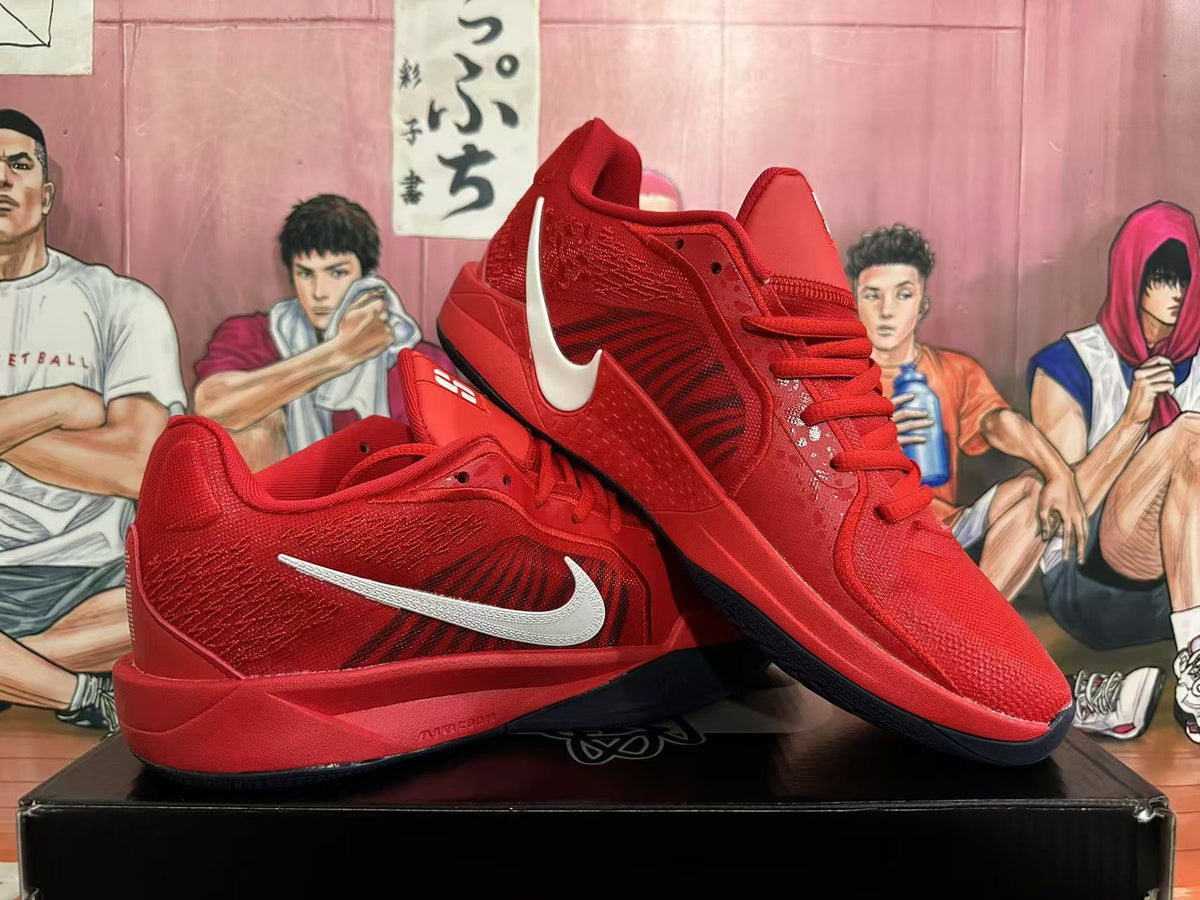 Pair of red Nike basketball shoes showing silver Swoosh accents and dark outsoles.