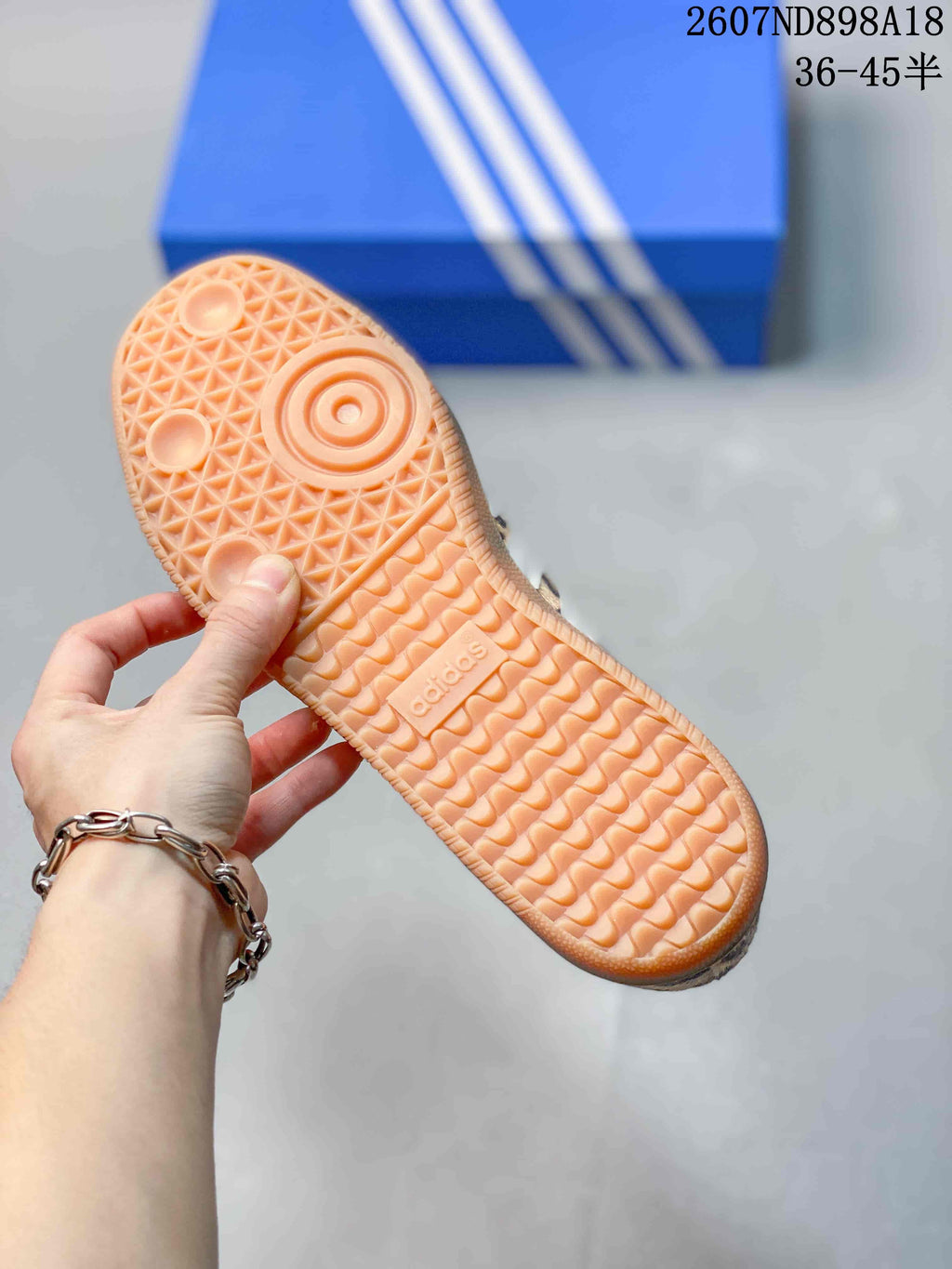 Close-up of the sneaker's gum-colored rubber outsole with a textured tread pattern.