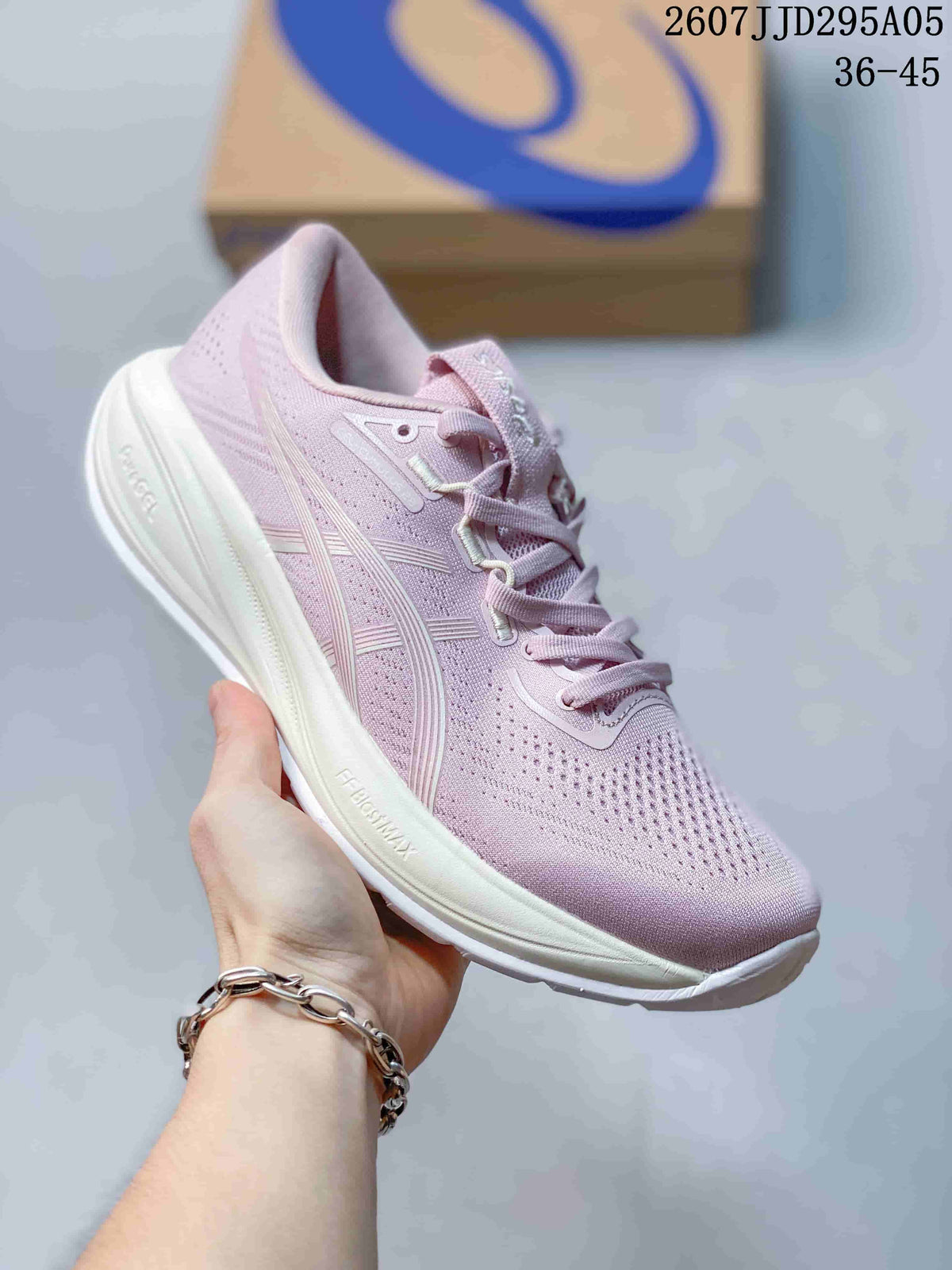 Angled side view of the pink ASICS sneaker showing the breathable upper, side branding, and white cushioned sole.