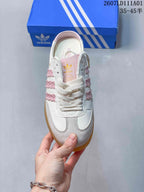 Top view of the laced white and pink Samba OG Mule sneaker