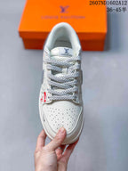 Top view showing the perforated white toe box, braided gray-and-white laces, padded tongue, and visible Louis Vuitton text and monogram-style graphics.