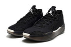 Pair of black Jordan low-top sneakers with white tongue logos.