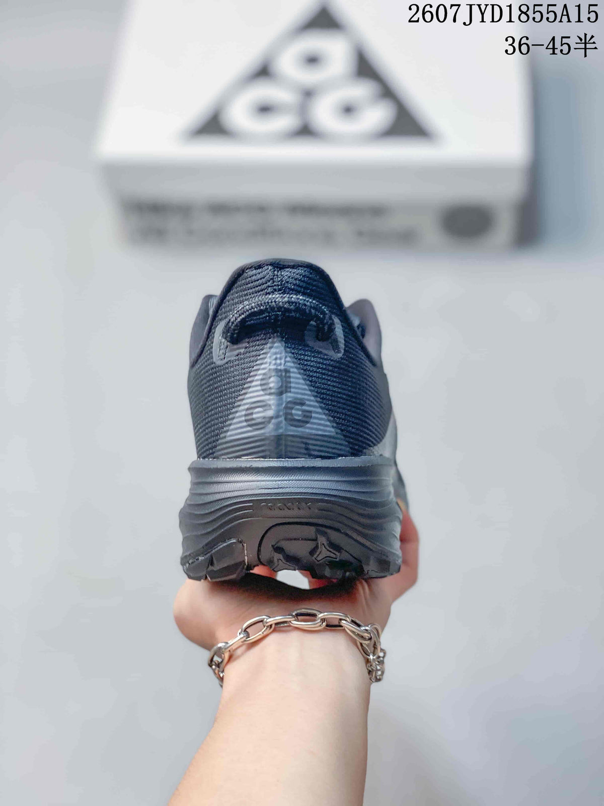 Rear view of a dark gray Nike ACG Pegasus Trail sneaker showing the heel branding and layered outsole.