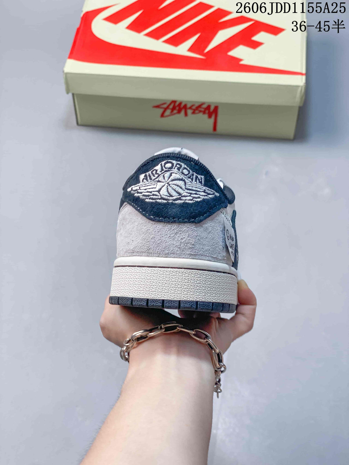 Rear view showing the embroidered winged basketball logo on the navy heel tab and a light gray heel panel.