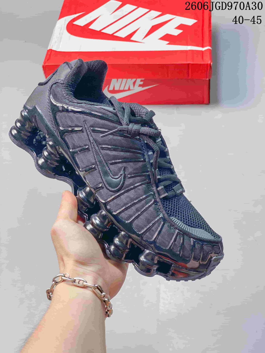 Dark Nike Shox TL sneaker shown from the side