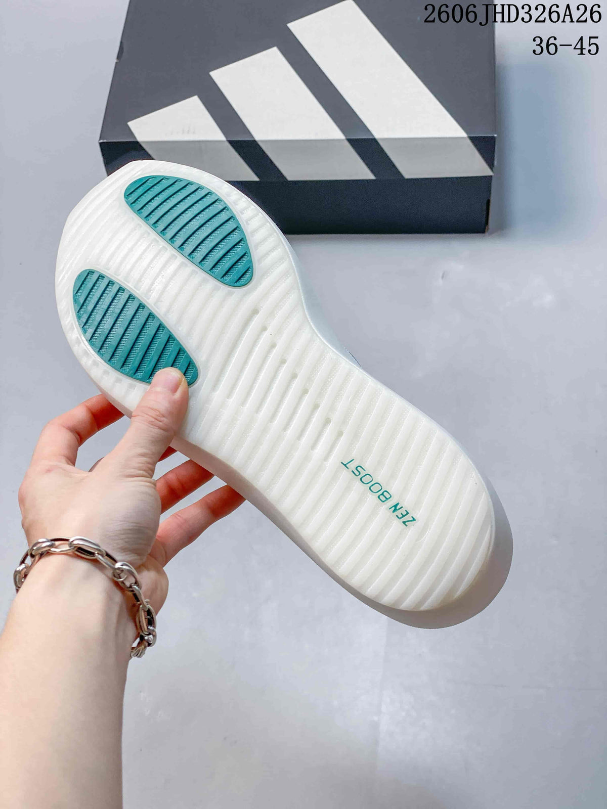 Underside of the white shoe showing teal traction sections
