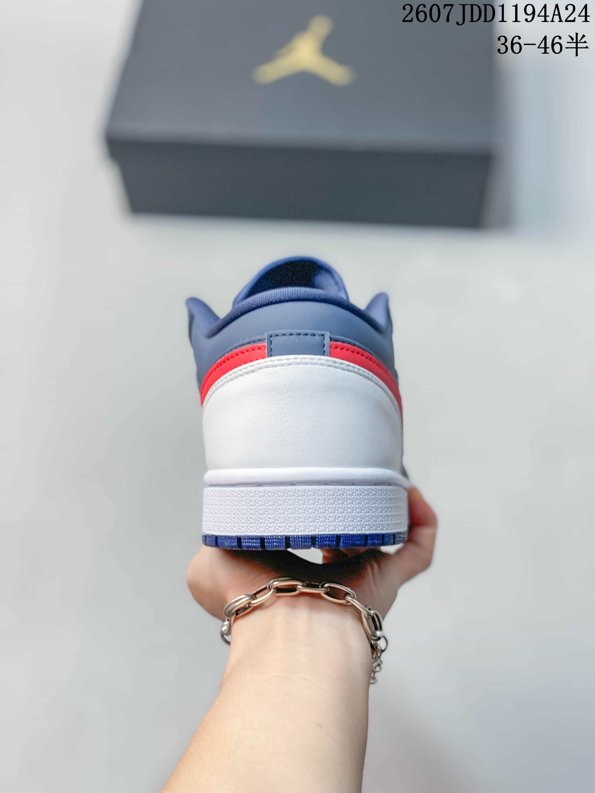 Rear view showing the white heel, red accent strip, and navy collar of the sneaker.