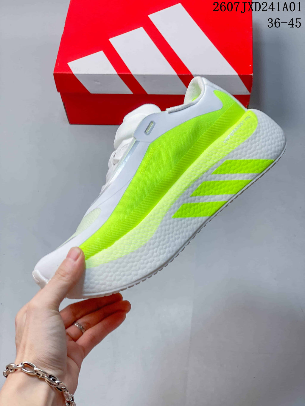 Side view of the white running shoe with a bright neon-yellow panel and three-stripe detailing.