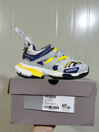 Balenciaga Track sneaker displayed on its box, showing the side profile and a product label marked Track Sneaker, color white, navy, light yellow and grey, size C 37.