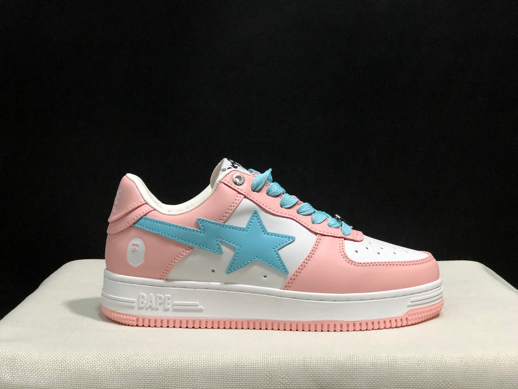 Close side view of one sneaker showing the pink and white upper, light-blue side emblem, and pink outsole edge.