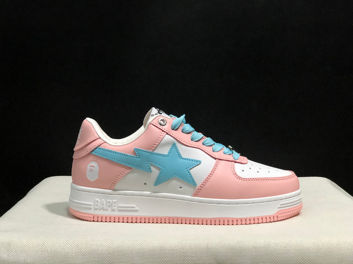 Close side view of one sneaker showing the pink and white upper, light-blue side emblem, and pink outsole edge.