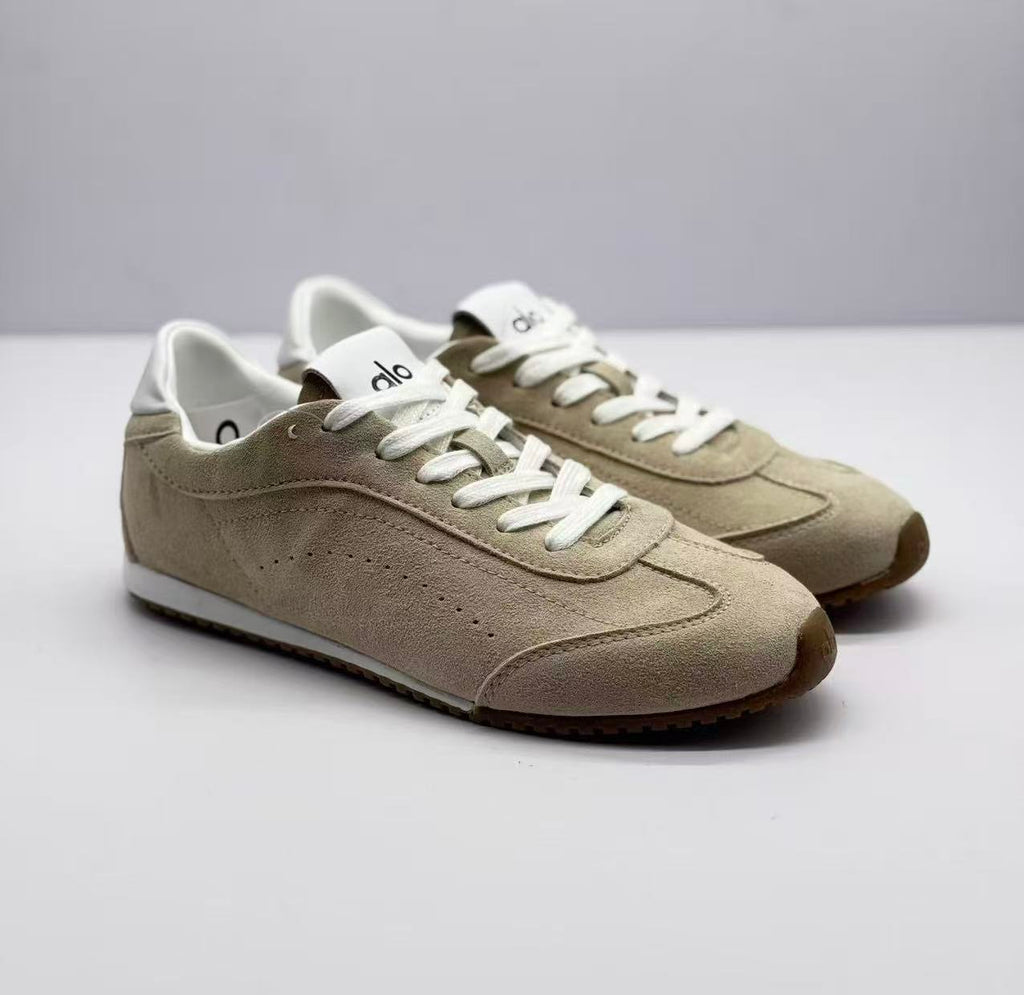 Pair of beige lace-up sneakers shown from a front three-quarter angle.
