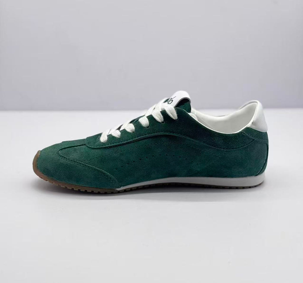 Opposite side profile of a green Alo low-top sneaker with white laces and a contrasting white midsole.