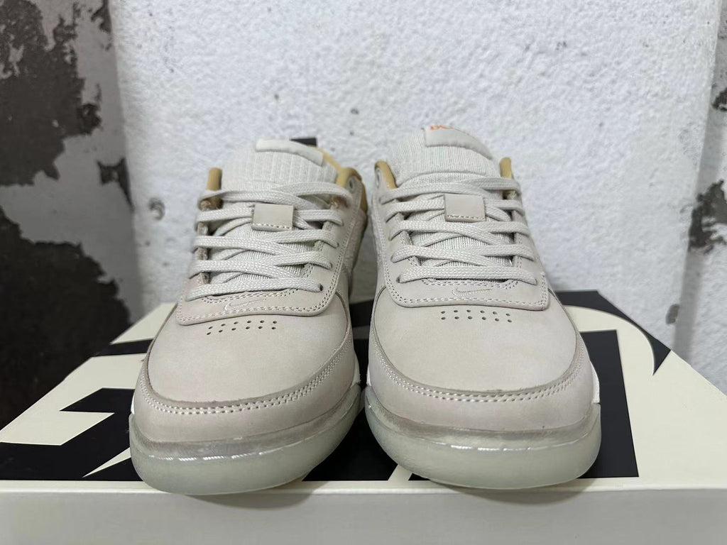 Front view of cream and light grey Nike Book 1 sneakers with lace-up closure