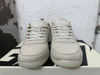 Front view of cream and light grey Nike Book 1 sneakers with lace-up closure