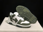 Angled view of the sneakers with one shoe lifted to show the patterned dark outsole tread.