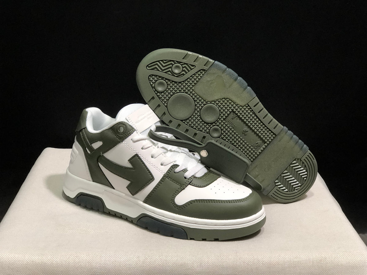 Angled view of the sneakers with one shoe lifted to show the patterned dark outsole tread.