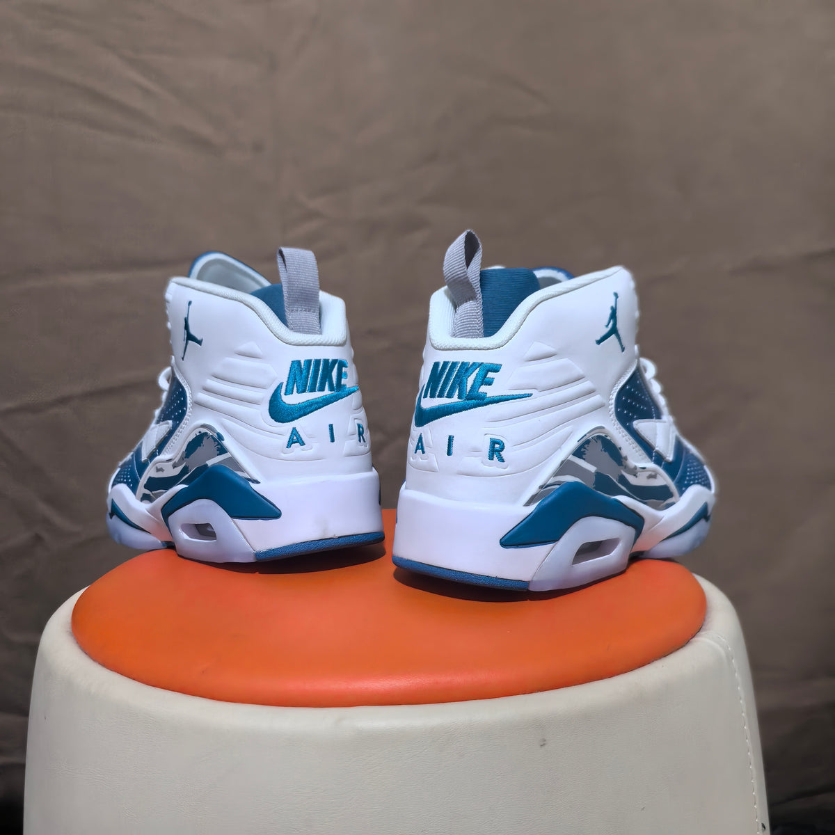 Rear view of the pair with Nike Air lettering and blue accents