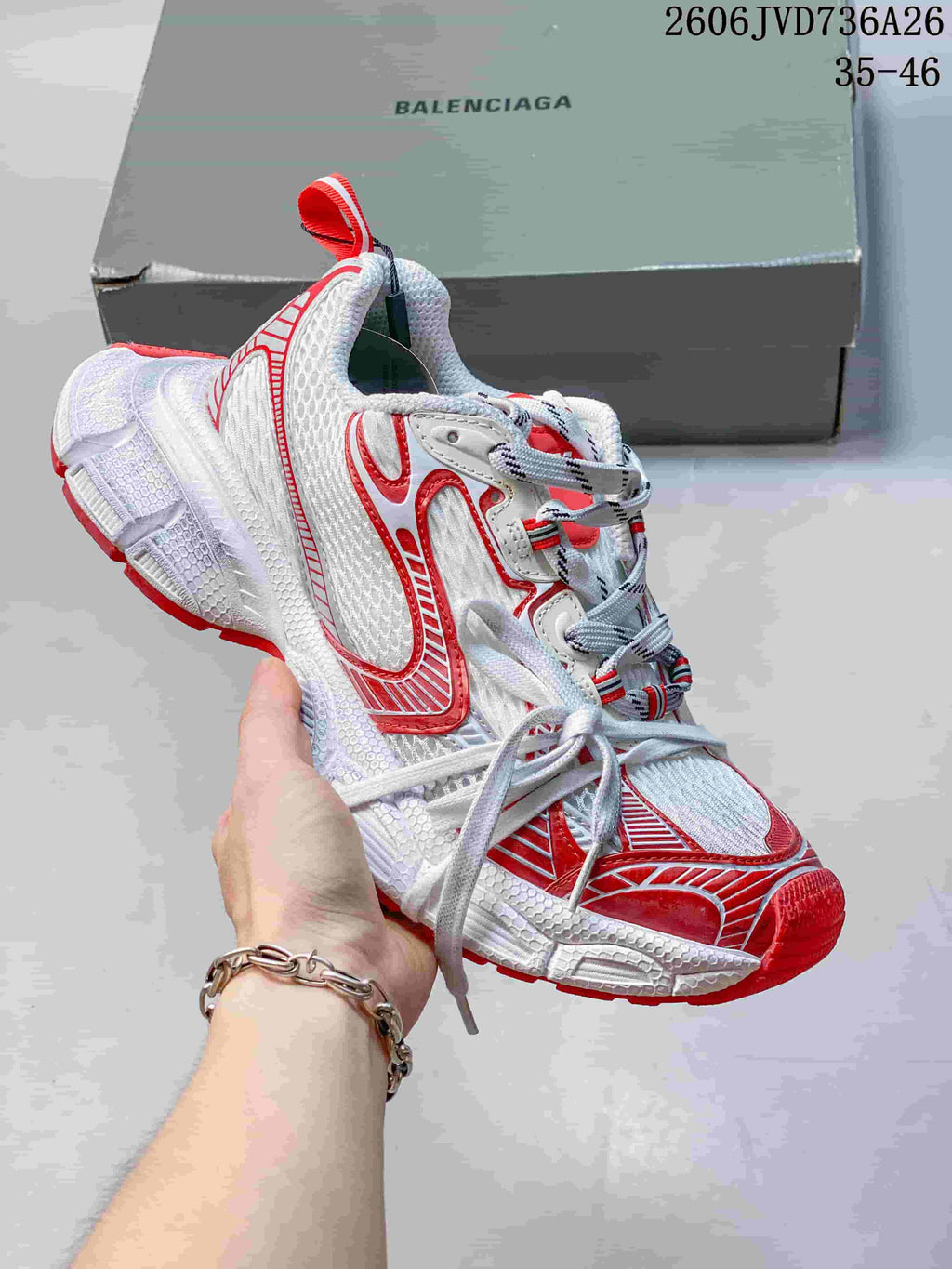 White Balenciaga 3XL-style sneaker with red accents and a chunky sole