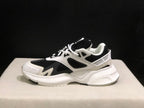 Side profile showing the layered upper, mesh panels and sculpted white outsole.