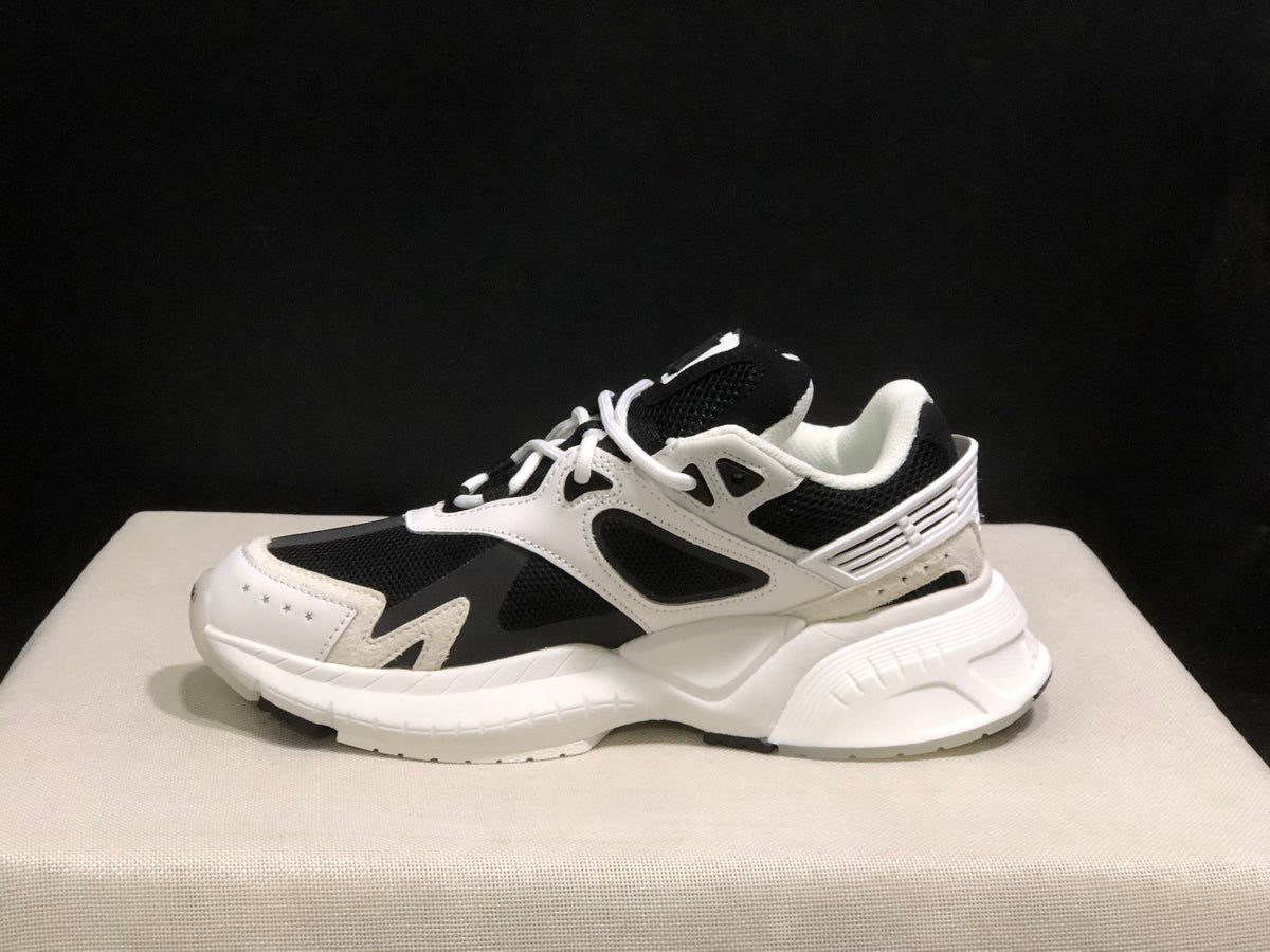 Side profile showing the layered upper, mesh panels and sculpted white outsole.