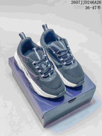 Pair of black and white Dior low-top sneakers displayed on a shoe box, showing the rounded toe, layered upper, and thick sole.