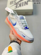 Angled side view of the white Nike SB PS8 sneaker with blue Swoosh details and orange outsole accents.