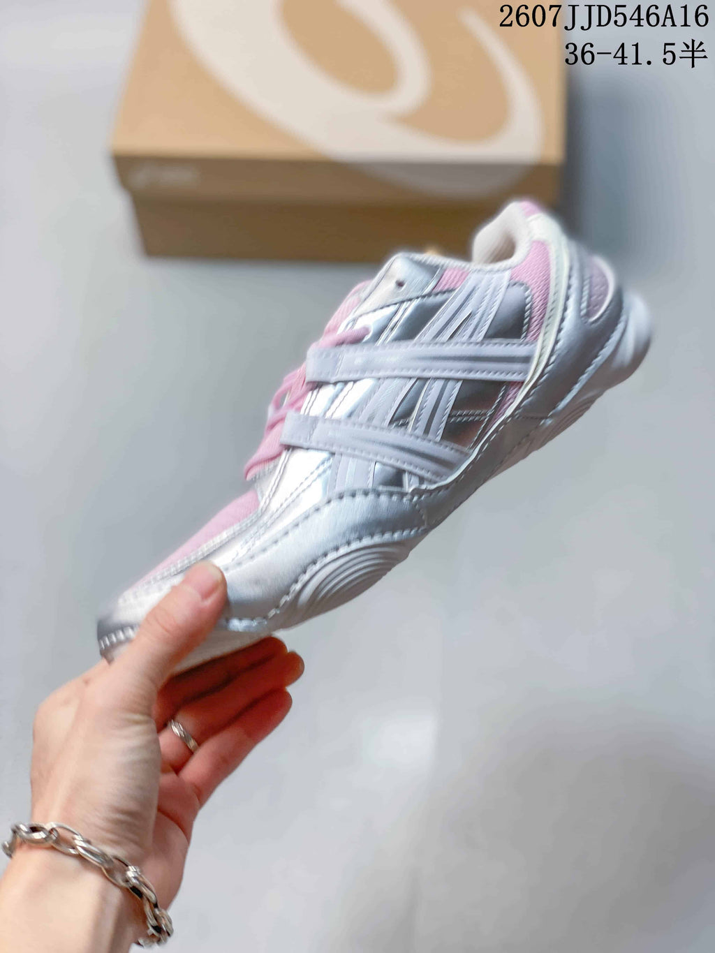 Side view of the silver and pink ASICS Hypersync sneaker with layered detailing and a low-profile sole.
