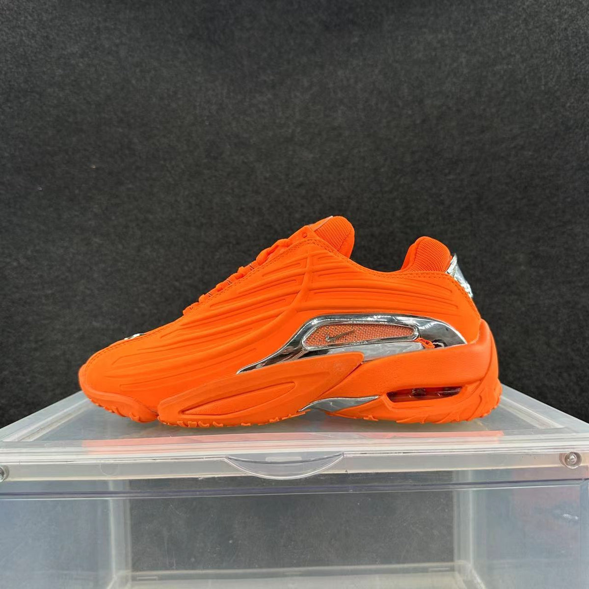Bright orange low-top sneaker with metallic-look side detailing