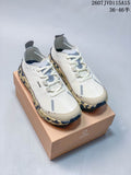 White NORDA 001 G+ sneakers displayed on a branded box, showing gray overlays and a patterned dark outsole.