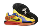 Yellow, blue, red, and orange Sabrina 2 shoe beside a view of its black patterned outsole.