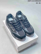 Pair of black Premiata Lander trainers displayed on a shoebox, showing the side logo and printed midsole graphics.