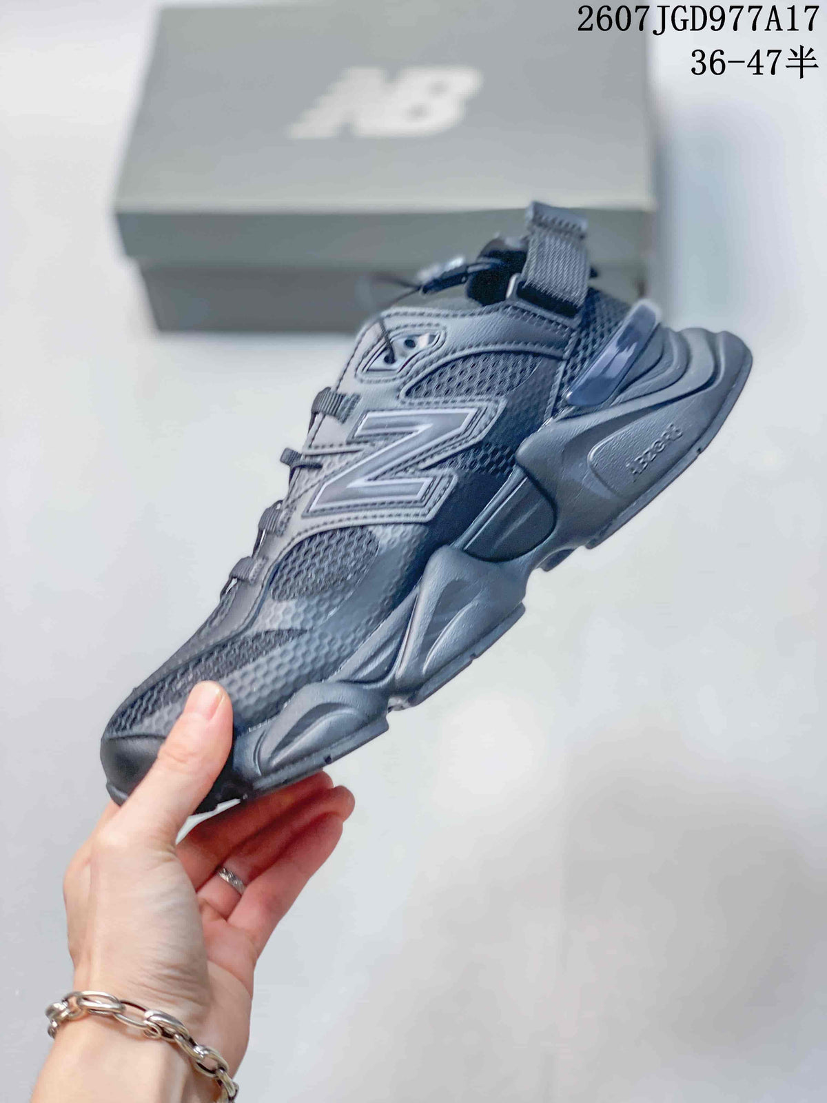 Side profile of the New Balance 9060 mule sneaker showing the layered upper, large side logo, mesh panels, and sculpted sole.